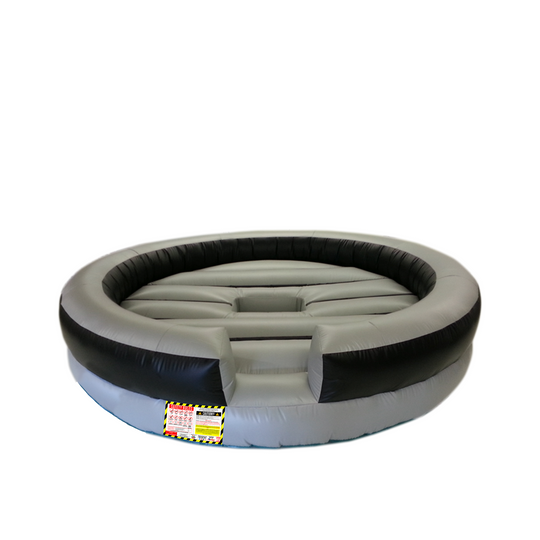 Round grey mechanical bull bed with black edges, designed for safety during bull riding activities. Round grey mechanical bull bed with black edges, designed for safety during bull riding activities.