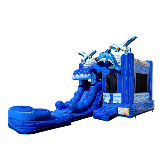 Bright blue inflatable combo water slide featuring dolphin designs, with a slide and bounce area. Bright blue inflatable combo water slide featuring dolphin designs, with a slide and bounce area.