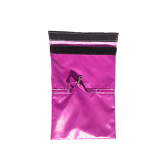 Bright pink sandbag cover designed for securing a commercial bounce house.