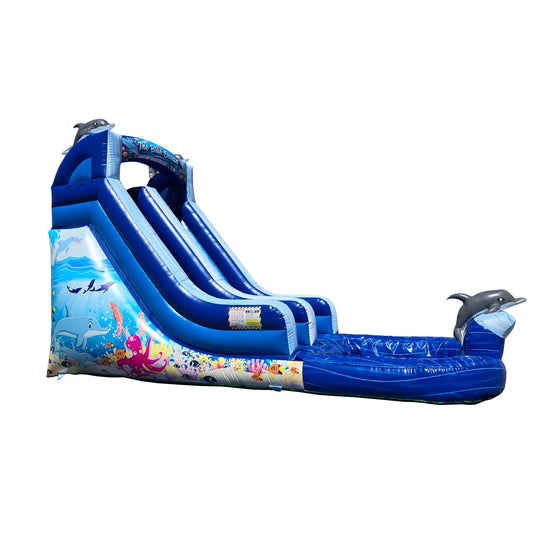 A vibrant blue inflatable water slide featuring dolphin accents, with two steep slides leading into a splash pool, ideal for