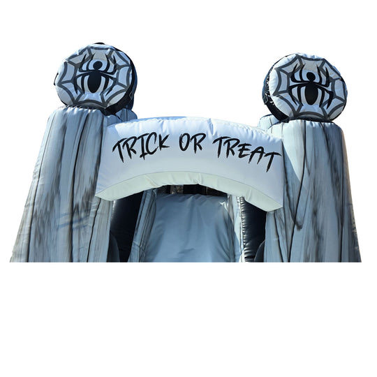 Halloween-themed inflatable entrance with spider decorations and 'TRICK OR TREAT' banner, part of a commercial inflatable