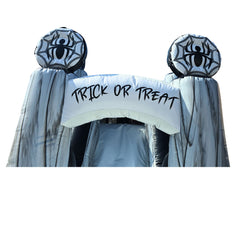 Halloween-themed inflatable entrance with spider decorations and 'TRICK OR TREAT' banner, part of a commercial inflatable