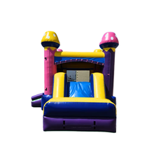 Colorful pink and yellow commercial inflatable combo with a slide and castle-like towers.