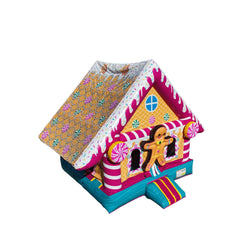 Gingerbread-themed pink bounce house with colorful candy decorations and a sloped roof, set against a white background.