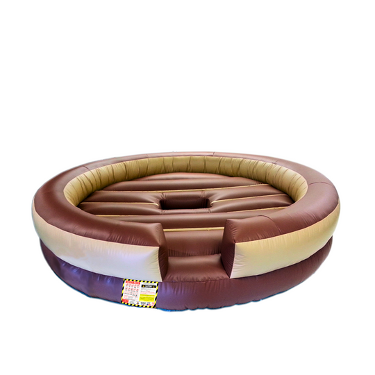 Round inflatable brown mechanical bull bed with cushioned sides, designed for safety and comfort.