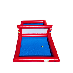 Red and blue inflatable volleyball court with a net, designed for commercial inflatable games for sale.