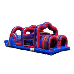 Colorful inflatable obstacle course featuring red and blue sections with tunnels and arches, set against a white background.