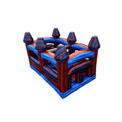 Dark inflatable obstacle course featuring vibrant red and blue colors with various climbing and sliding elements, set against