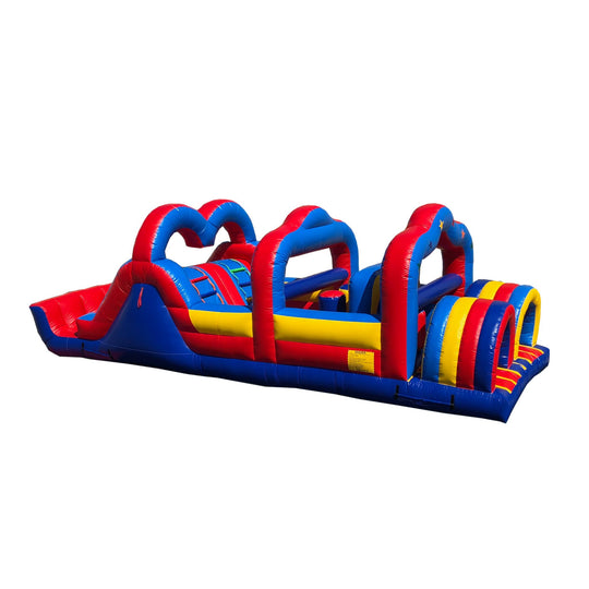 Colorful commercial obstacle course inflatable featuring red, blue, and yellow sections with various climbing and sliding