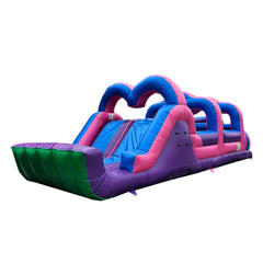 Colorful pink and purple commercial obstacle course inflatable for sale featuring slides and climbing sections.