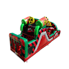 Colorful inflatable obstacle course designed as a toxic waste dump, featuring bright green and red colors with hazard
