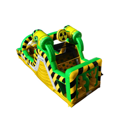 Bright yellow and green Toxic Waste Dump obstacle course featuring inflatable barrels and hazard stripes, set against a white