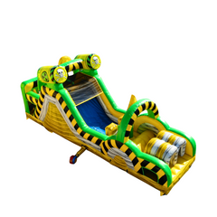 Brightly colored inflatable obstacle course featuring a toxic waste theme with yellow and green stripes, designed for fun and