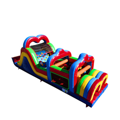 Colorful commercial obstacle course inflatable featuring various climbing and sliding sections, set against a white