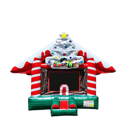 A festive Christmas-themed bouncy castle with red and white stripes, a decorated tree, and a green entrance, set against a